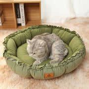 Grey calming pet bed with a supportive bolstered rim.

