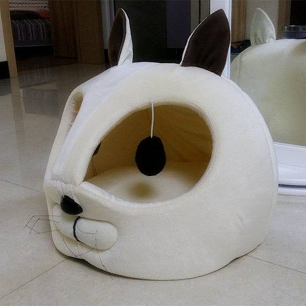 Comfortable dog bed with a panda-like design.
