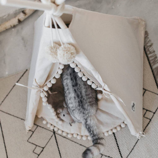Pet teepee with a soft cushion inside, offering a private retreat.
