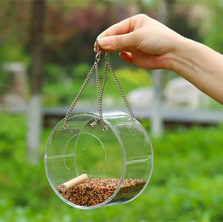 Acrylic bird food box with hanging chain, round design, 1000ml seed capacity.