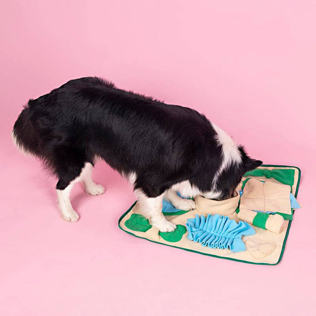 Green and beige pet snuffle mat for dogs, showing hidden treats.
