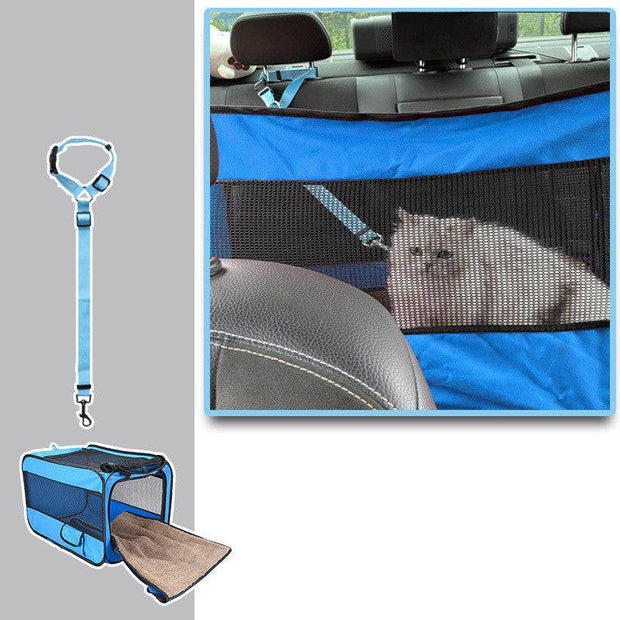 Blue folding pet travel cage in rear car seat with mesh panel and cat inside, secured with adjustable safety strap.