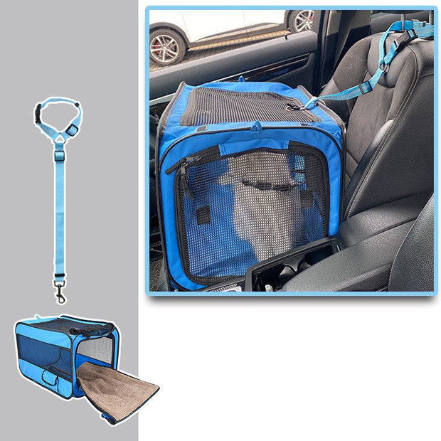 Blue folding pet carrier secured in front car seat with safety strap, mesh top and side for ventilation and visibility.